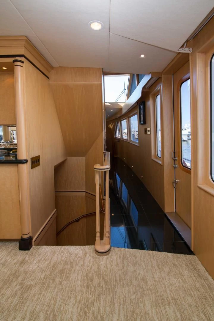 a hallway with a staircase and a railing aboard MALDAU Yacht for Sale