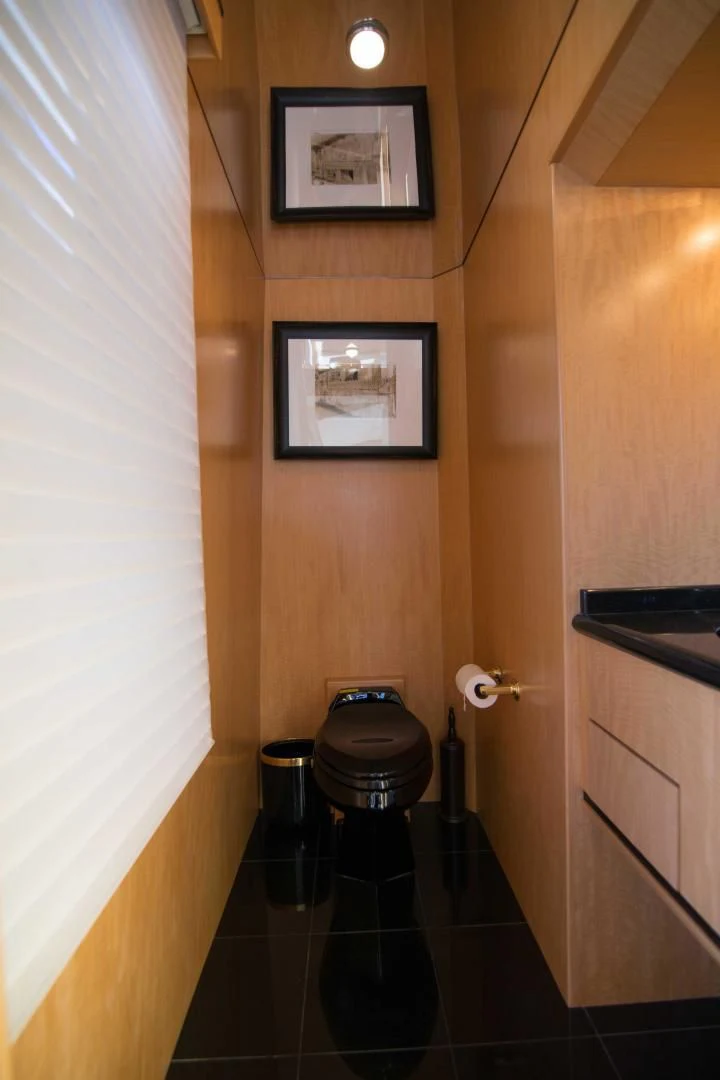 a bathroom with a toilet and a painting on the wall aboard MALDAU Yacht for Sale