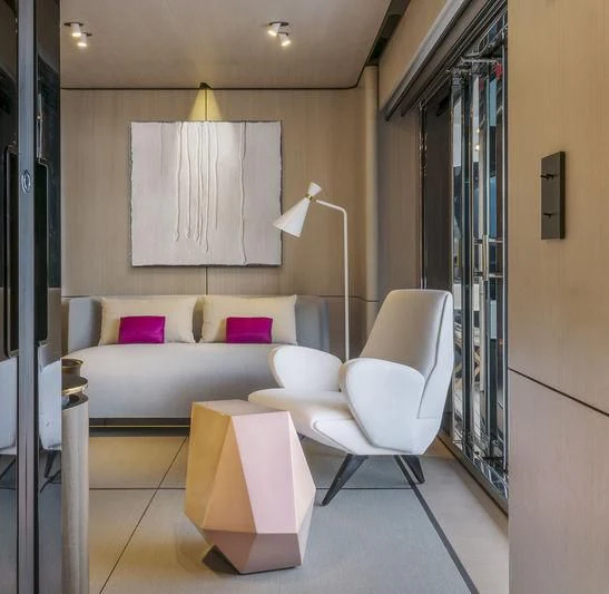 a room with a couch and a chair aboard ENDEAVOUR 2 Yacht for Sale