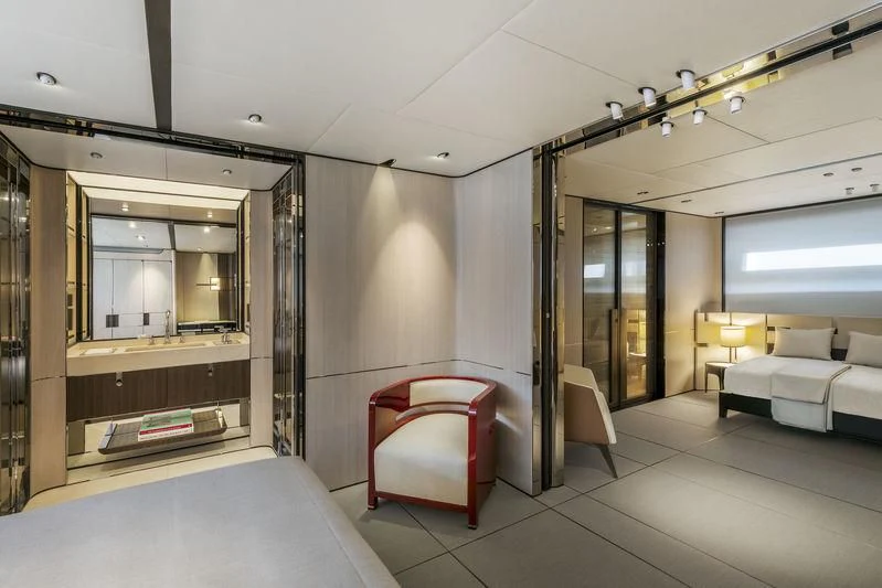 a room with a bed and a chair aboard ENDEAVOUR 2 Yacht for Sale