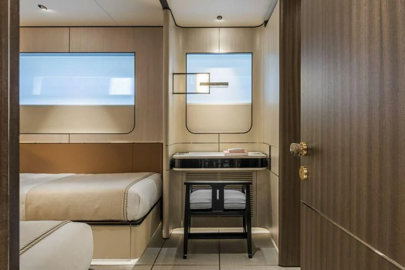 a room with a bed and a desk aboard ENDEAVOUR 2 Yacht for Sale