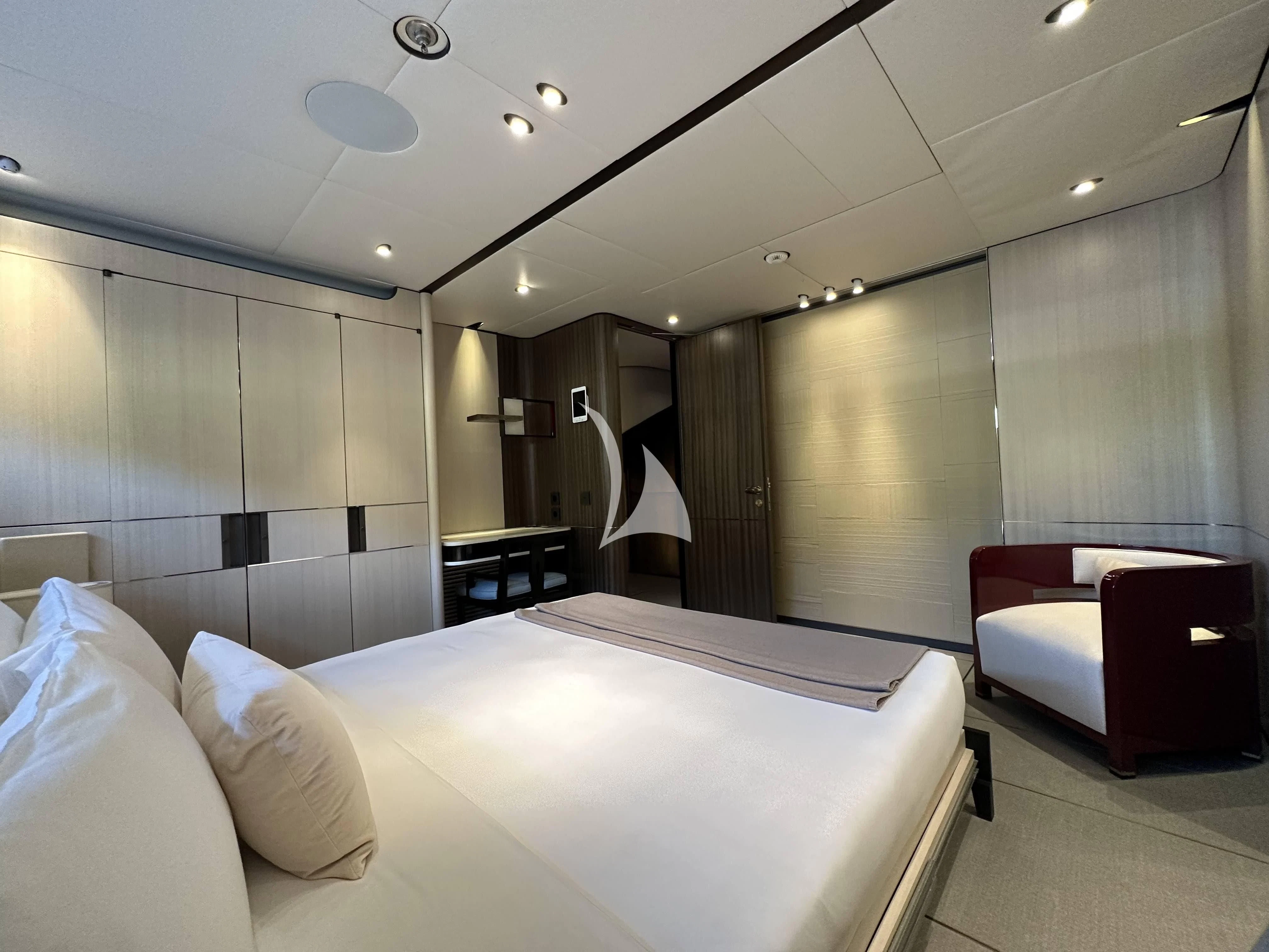 a hotel room with a bed and a chair aboard ENDEAVOUR 2 Yacht for Sale