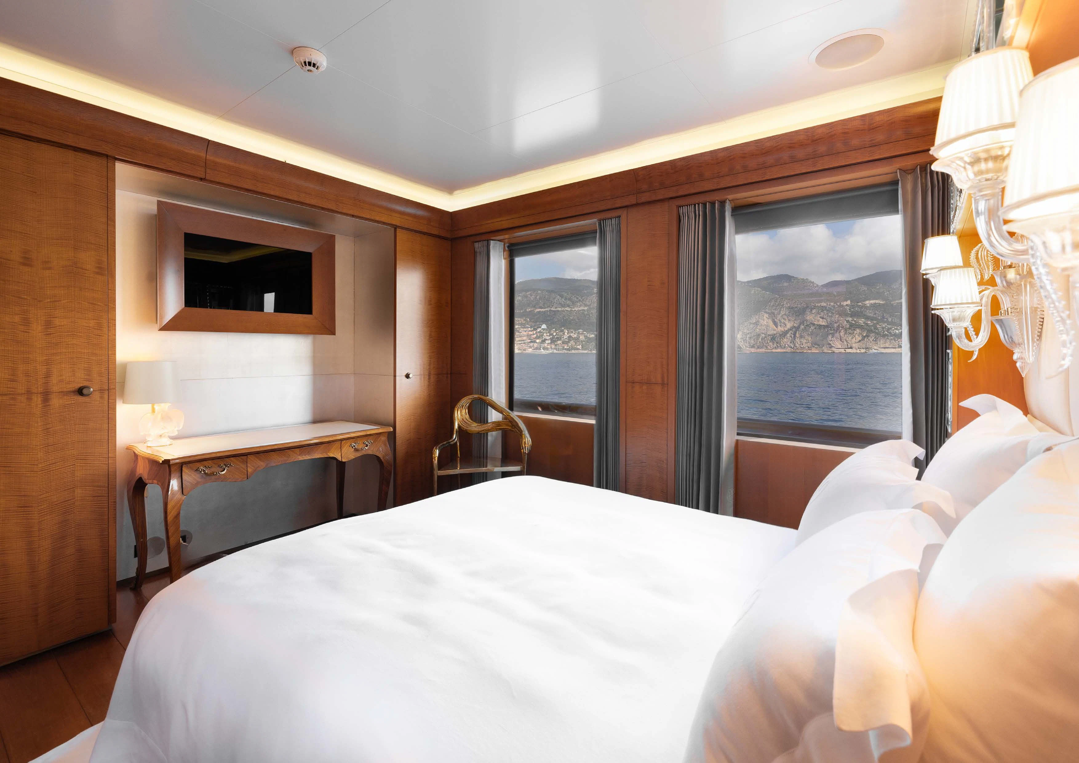 a room with a bed and a television aboard WEDGE TOO Yacht for Sale
