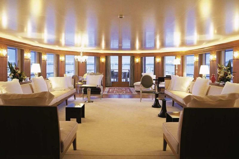 a large room with many couches aboard WEDGE TOO Yacht for Sale
