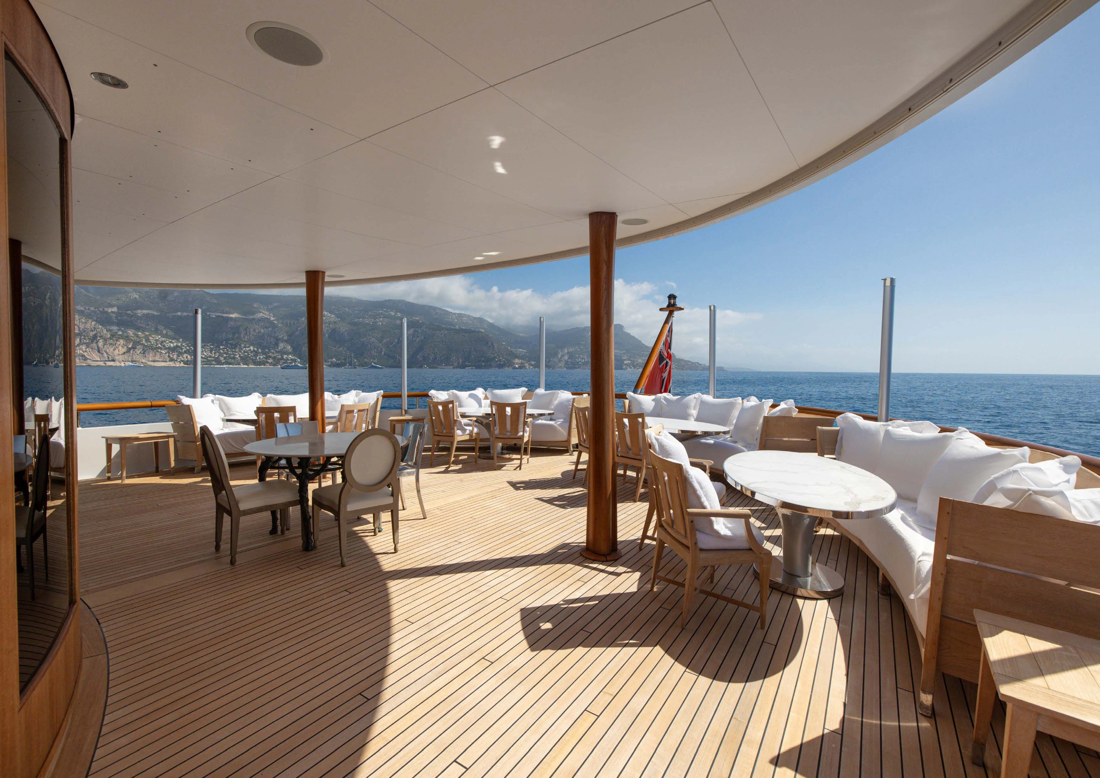 a room with tables and chairs aboard WEDGE TOO Yacht for Sale