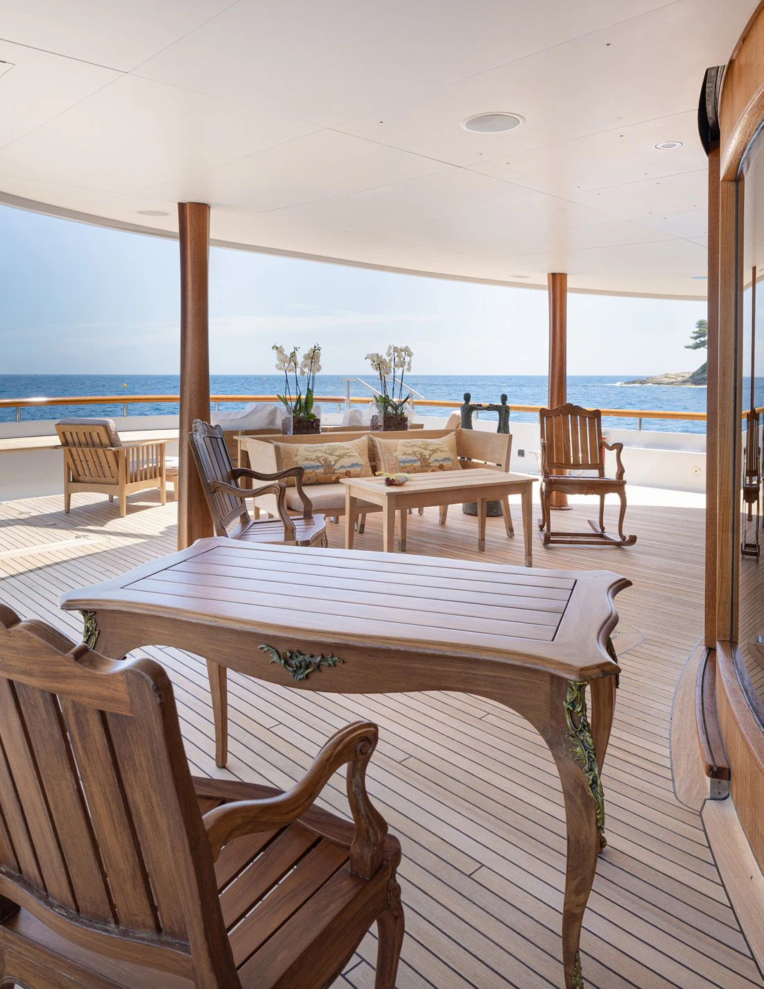 a table and chairs on a patio aboard WEDGE TOO Yacht for Sale