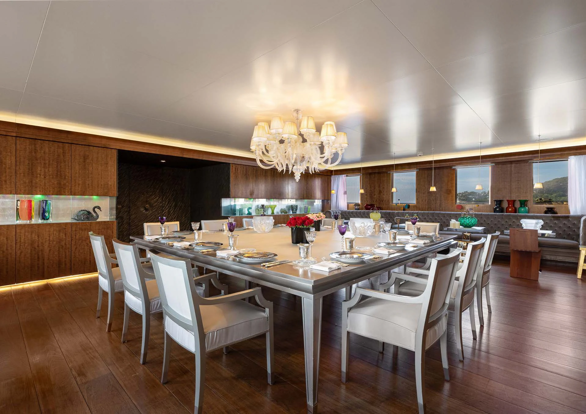 a large room with a table and chairs aboard WEDGE TOO Yacht for Sale