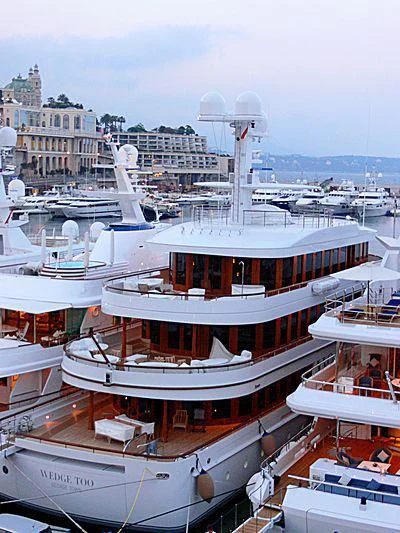 a large boat sits in a harbor aboard WEDGE TOO Yacht for Sale