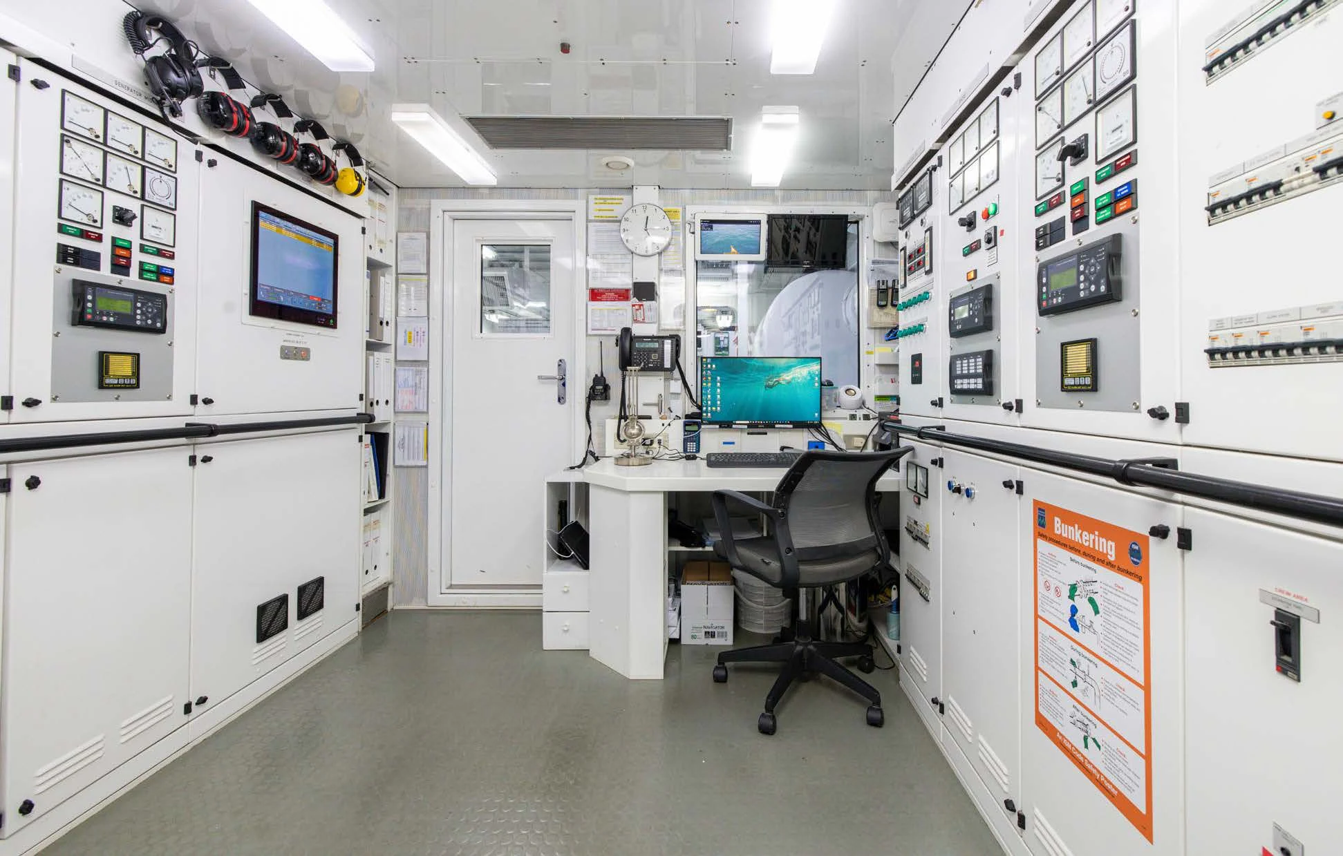 a room with white cabinets and a computer on a desk aboard WEDGE TOO Yacht for Sale