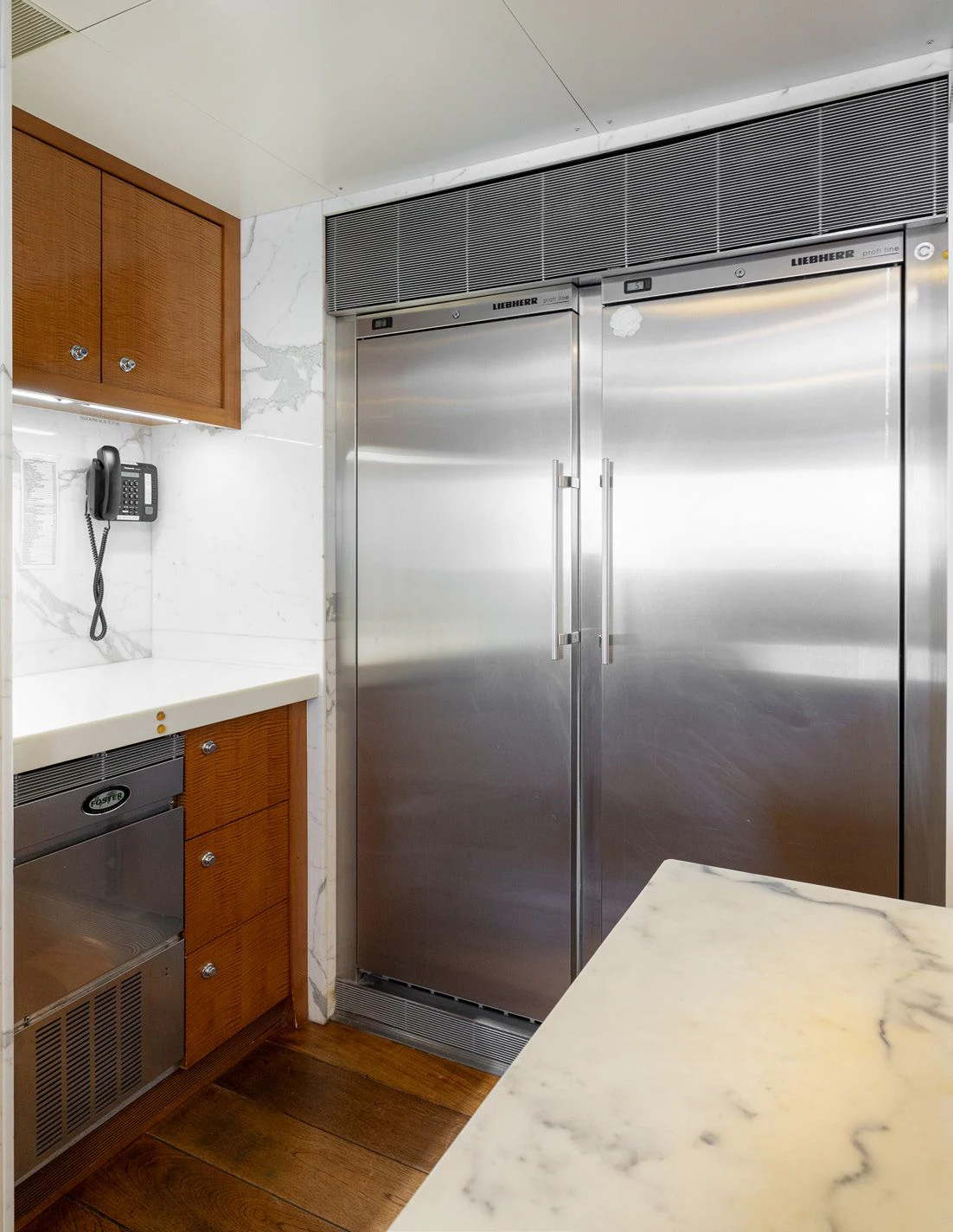 a kitchen with a refrigerator aboard WEDGE TOO Yacht for Sale