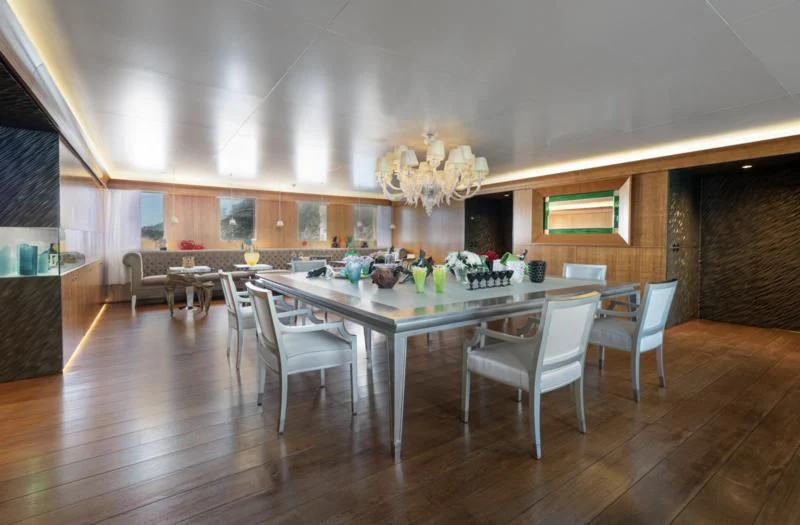 a large dining room with a large table and chairs aboard WEDGE TOO Yacht for Sale