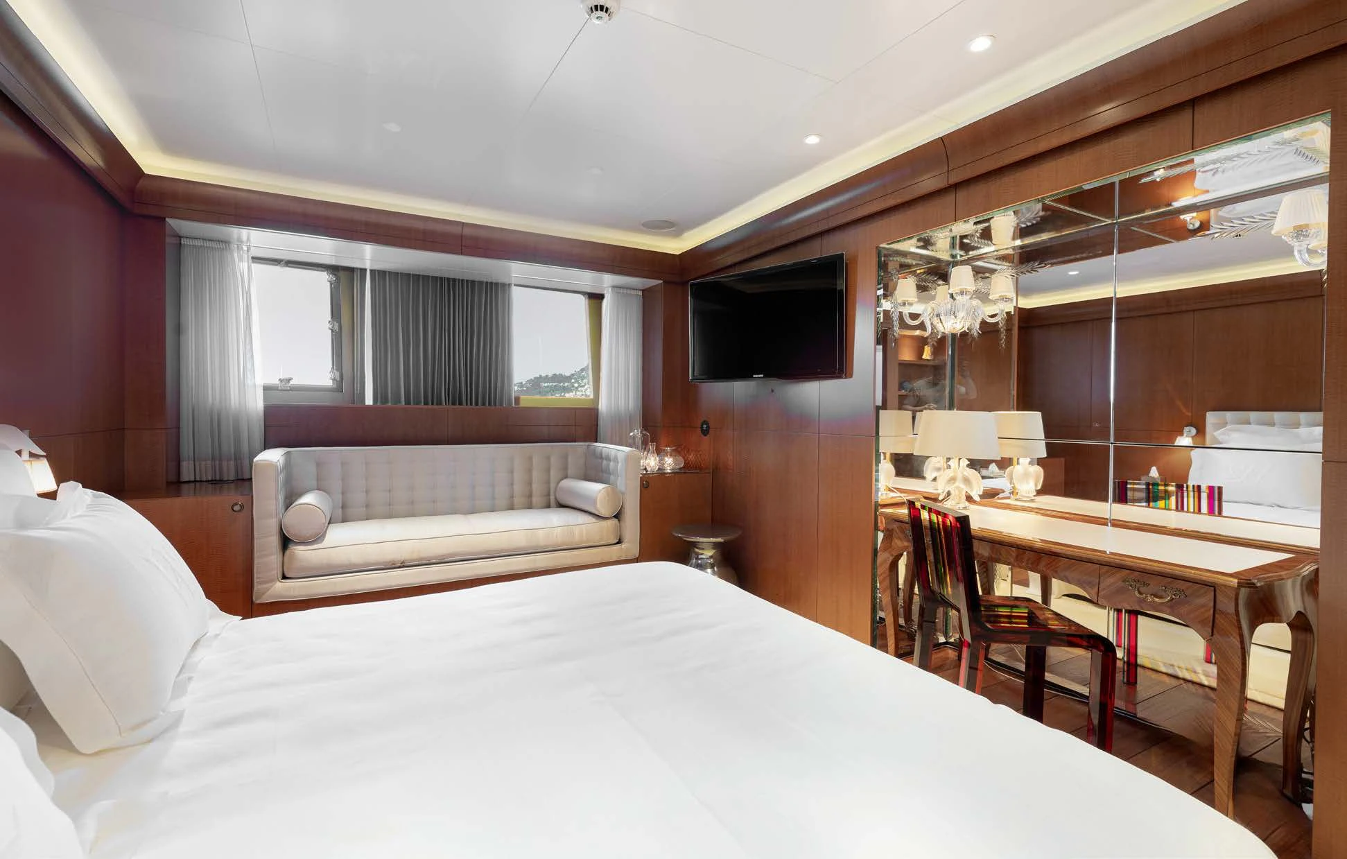 a bedroom with a bed and a desk aboard WEDGE TOO Yacht for Sale