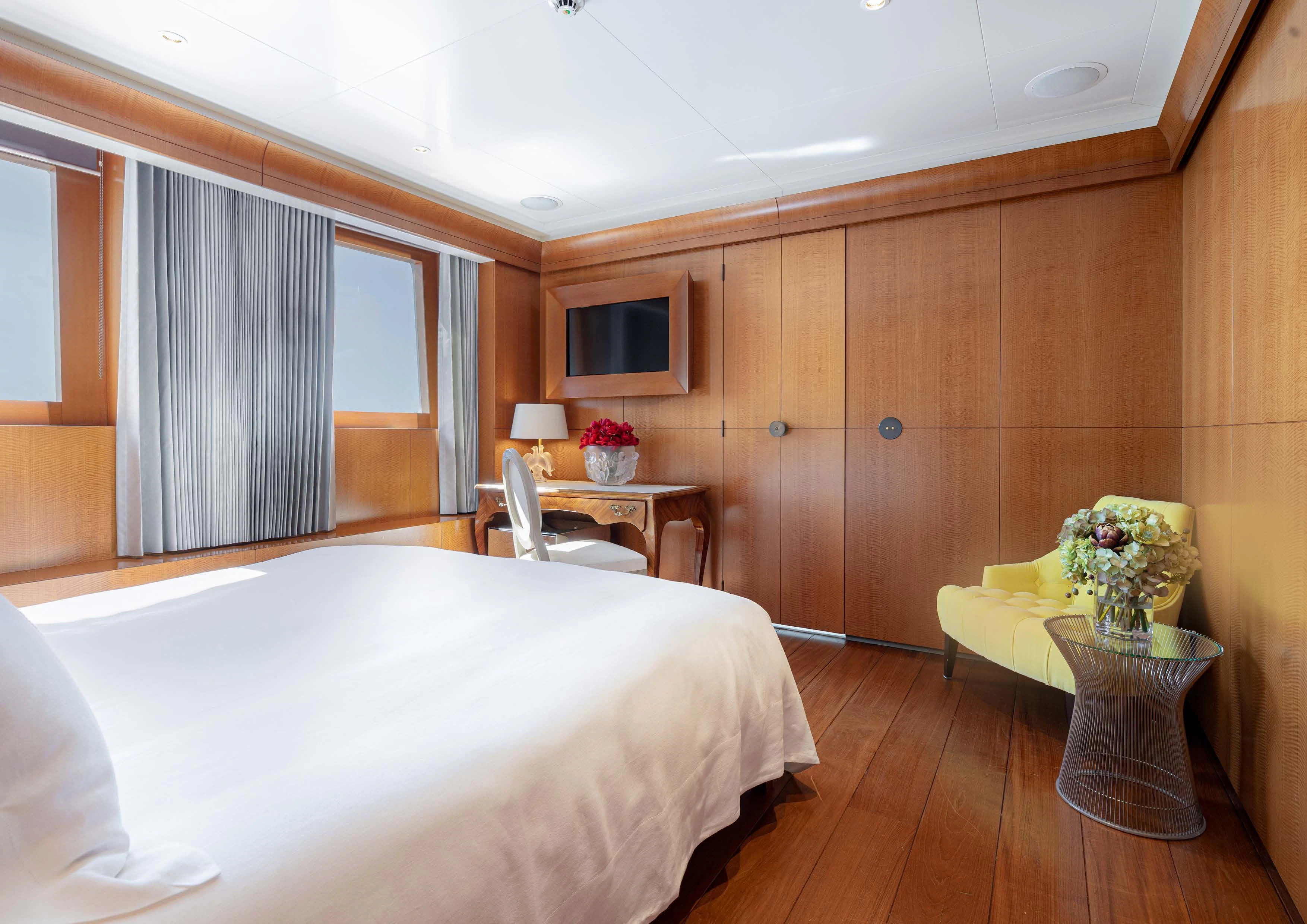 a room with a bed and a table aboard WEDGE TOO Yacht for Sale