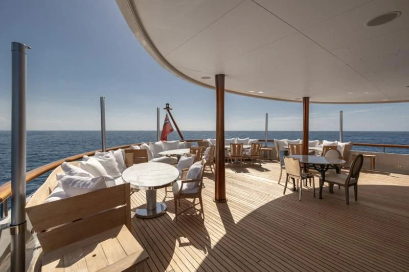 a deck with a large body of water and a large boat aboard WEDGE TOO Yacht for Sale
