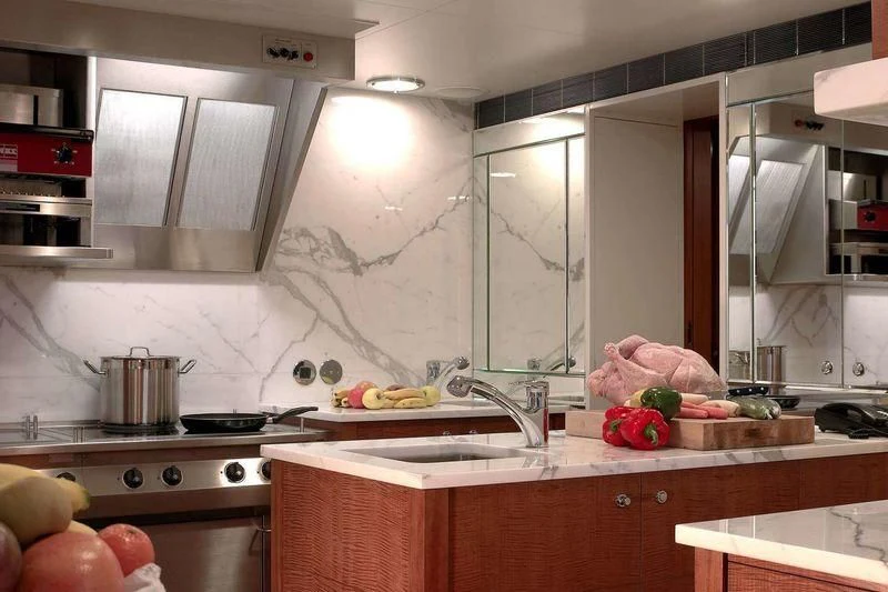 a kitchen with white walls aboard WEDGE TOO Yacht for Sale