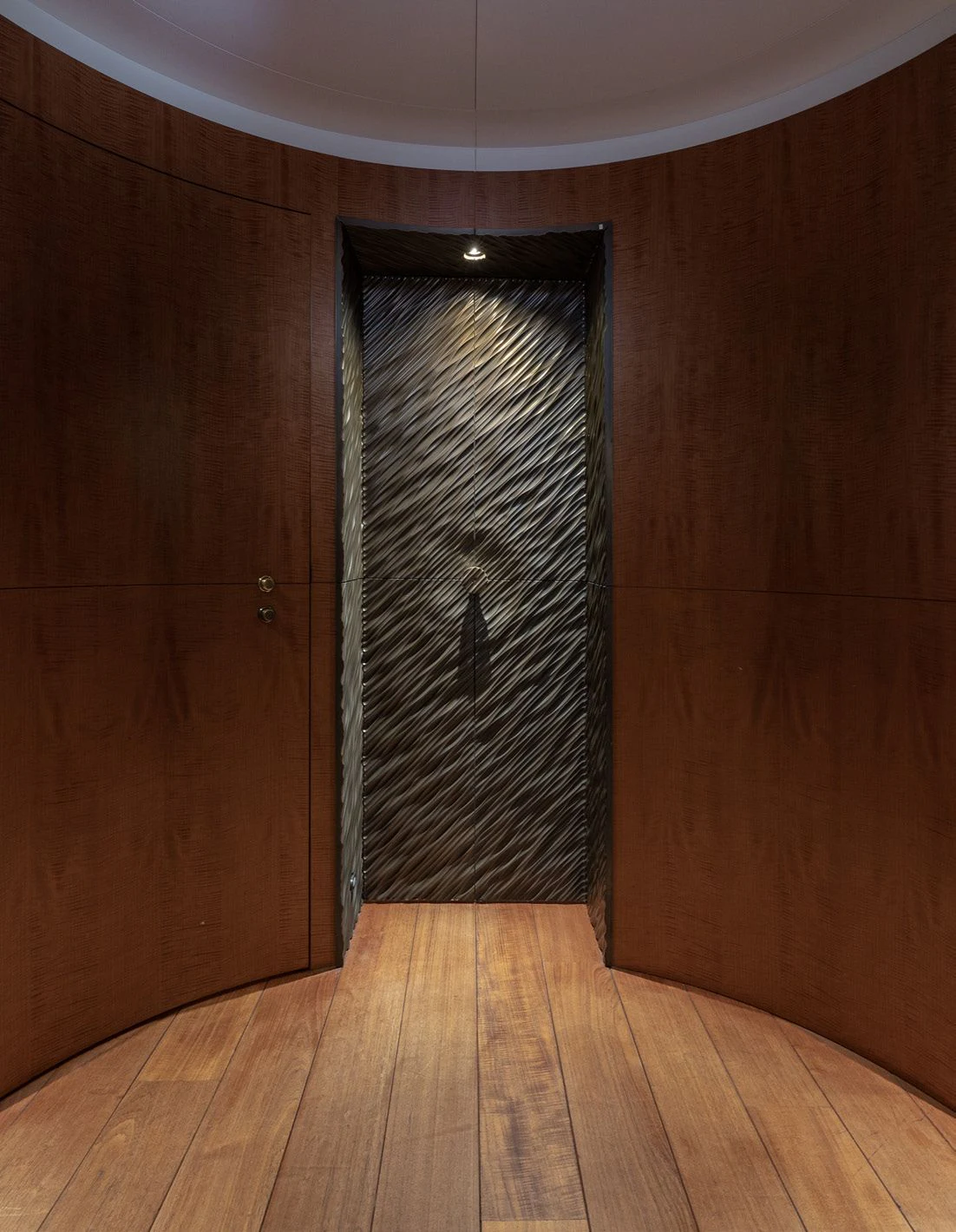 a dark wood room with a black door and a wood floor aboard WEDGE TOO Yacht for Sale