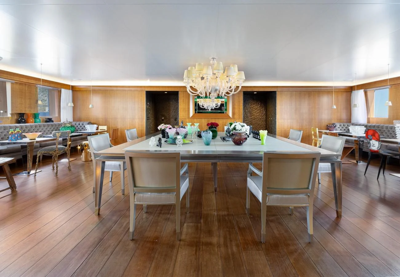 a large room with tables and chairs aboard WEDGE TOO Yacht for Sale