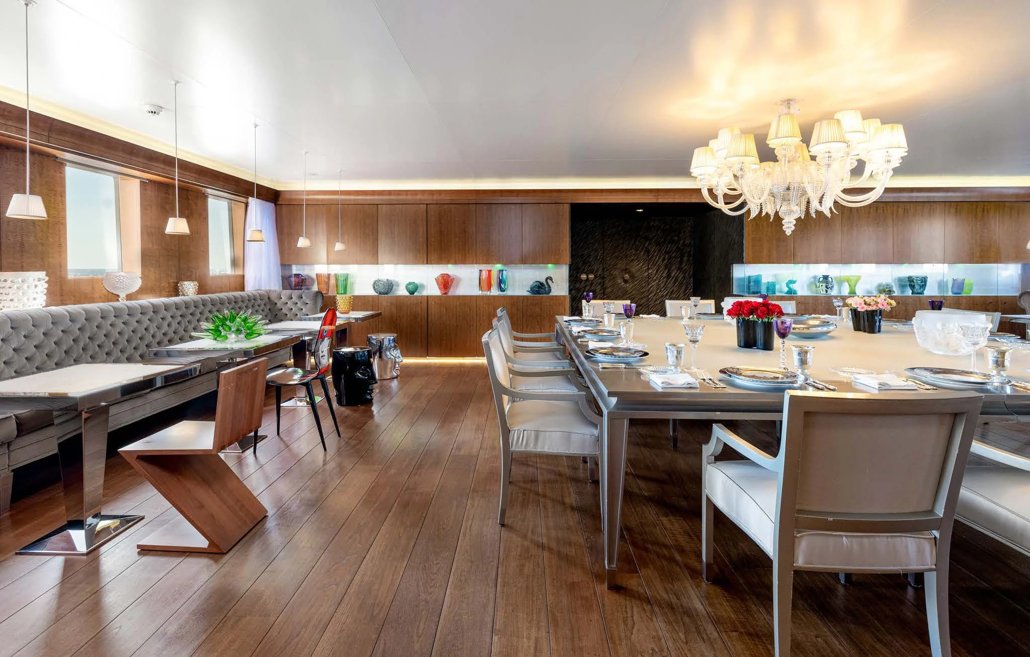 a large room with tables and chairs aboard WEDGE TOO Yacht for Sale