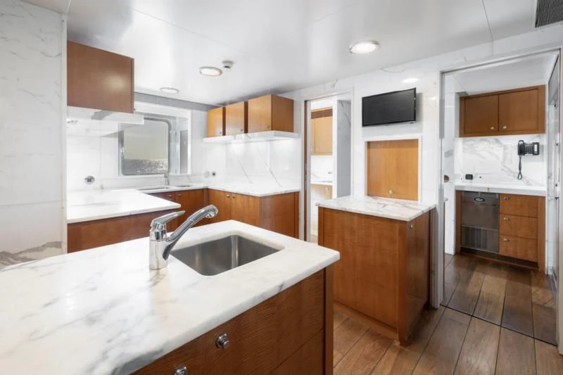 a kitchen with a sink and cabinets aboard WEDGE TOO Yacht for Sale