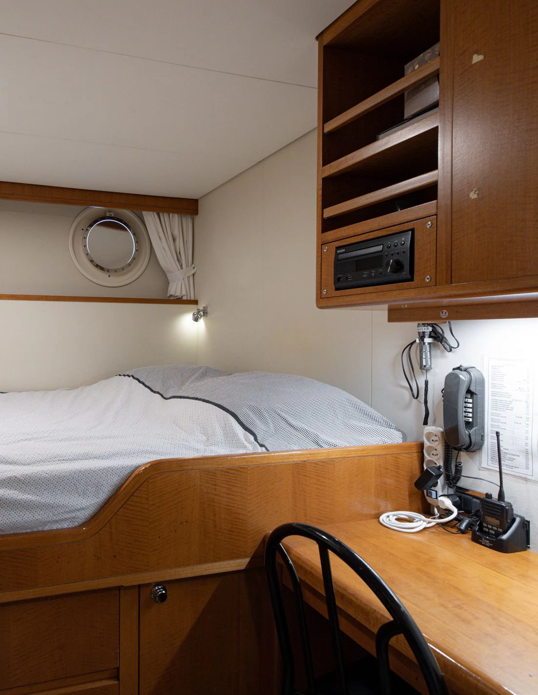 a bed with a telephone on it aboard WEDGE TOO Yacht for Sale