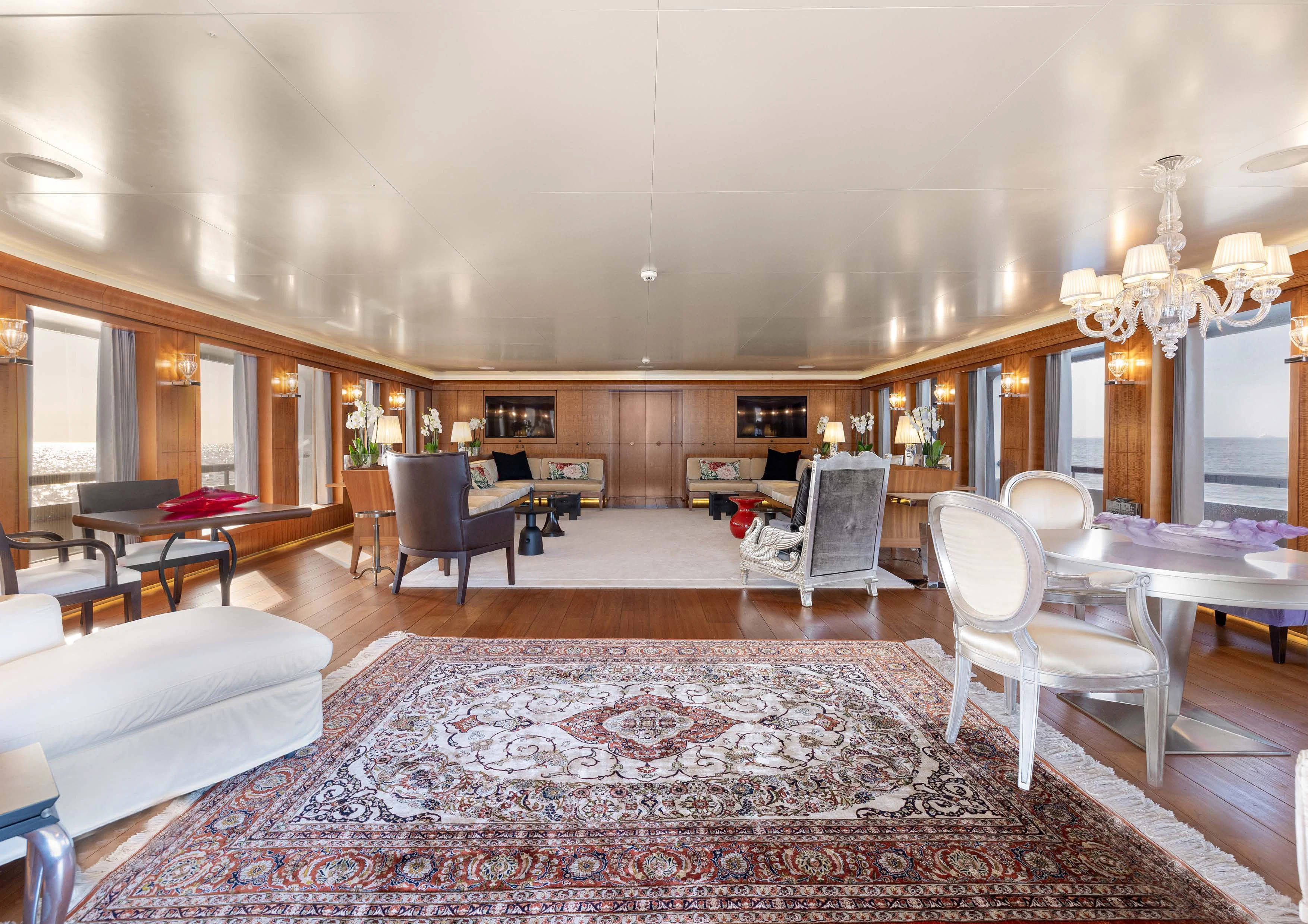 a large living room with a large rug aboard WEDGE TOO Yacht for Sale