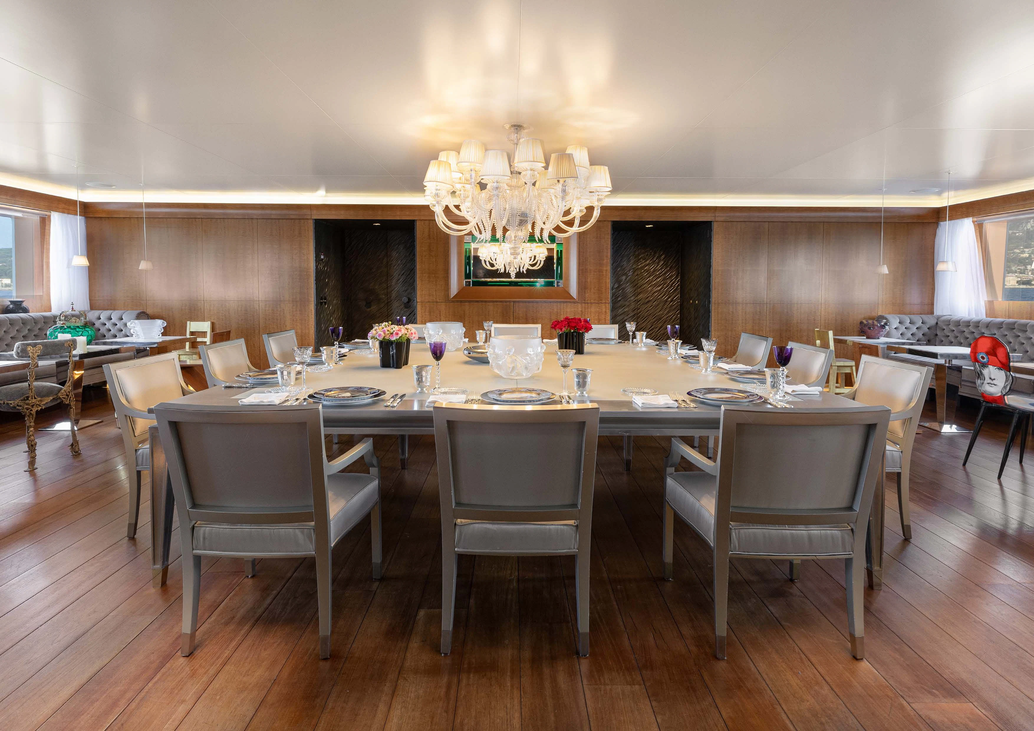 a large room with tables and chairs aboard WEDGE TOO Yacht for Sale