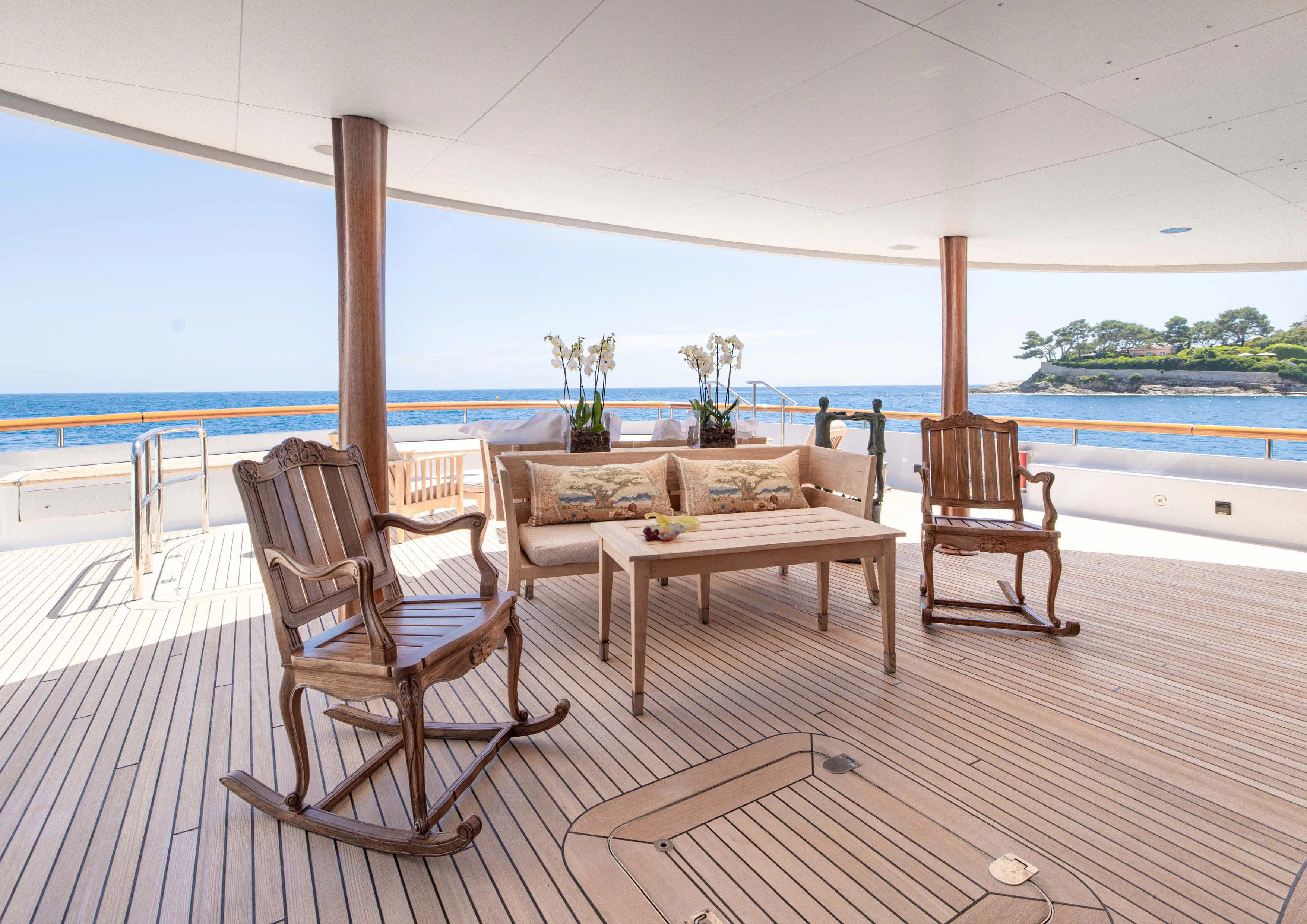 a table and chairs on a deck aboard WEDGE TOO Yacht for Sale