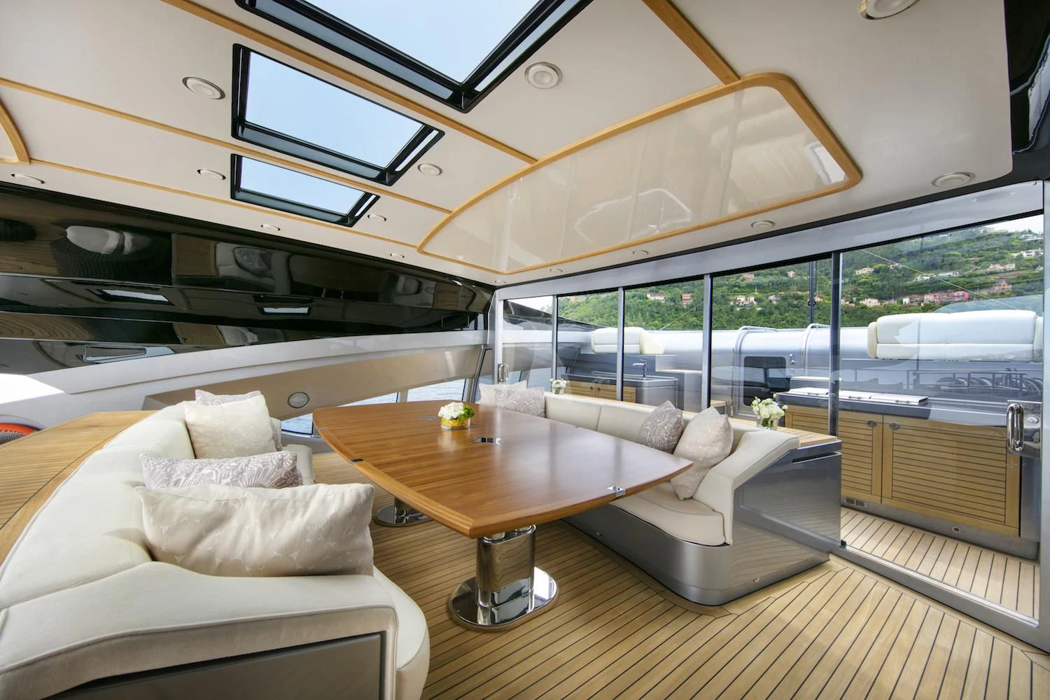 a room with a table and couches aboard FIVE Yacht for Sale