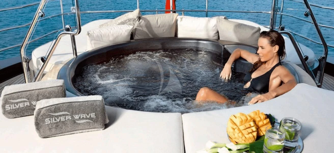 a person lying on a bed aboard FIVE Yacht for Sale