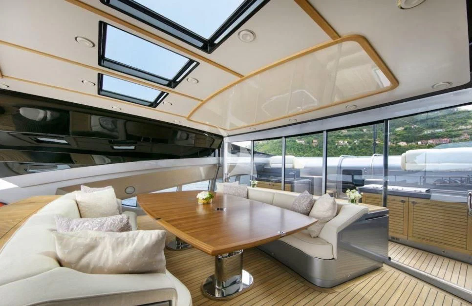 a room with a table and couches aboard FIVE Yacht for Sale