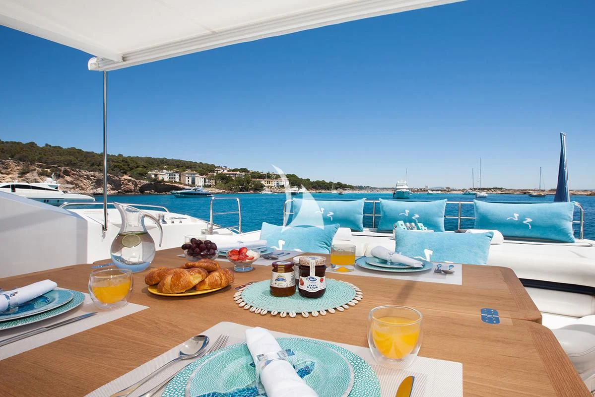 a table with food and drinks on it aboard FROGGY Yacht for Sale