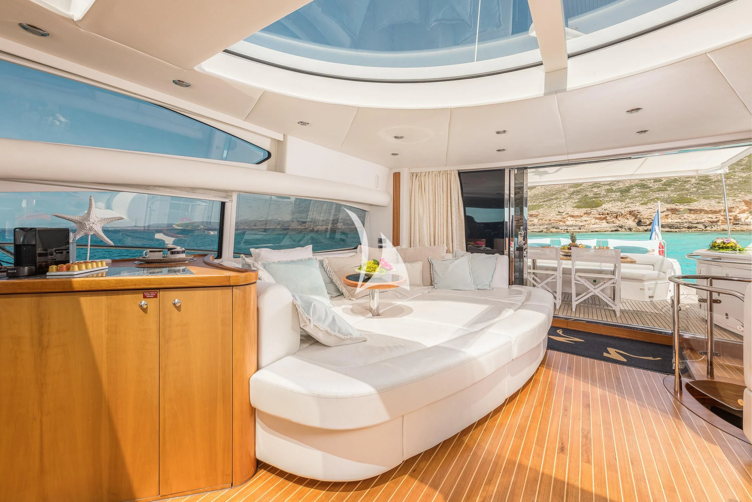 a room with a bed and a table and chairs aboard FROGGY Yacht for Sale