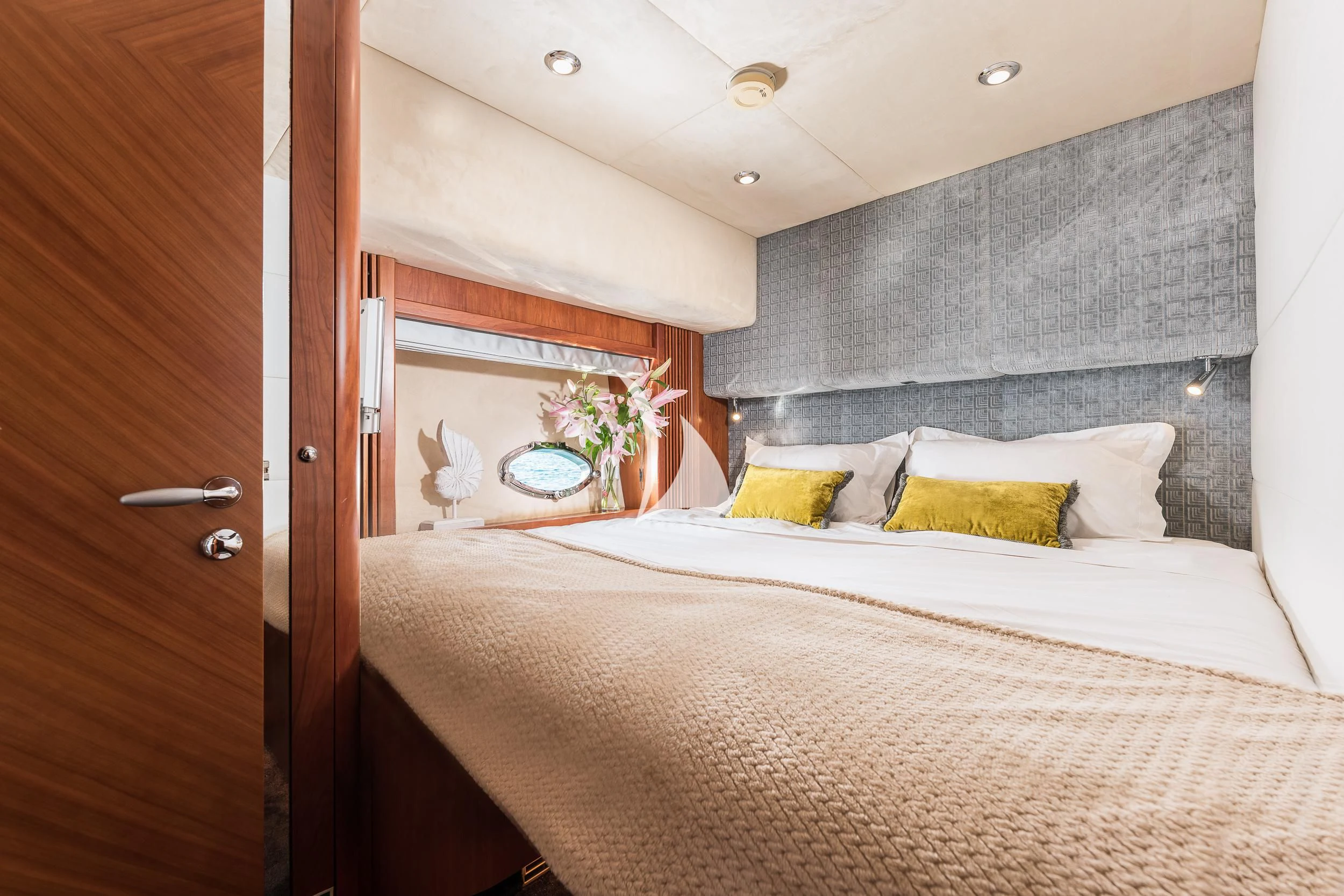 a bed with a white bed spread aboard FROGGY Yacht for Sale