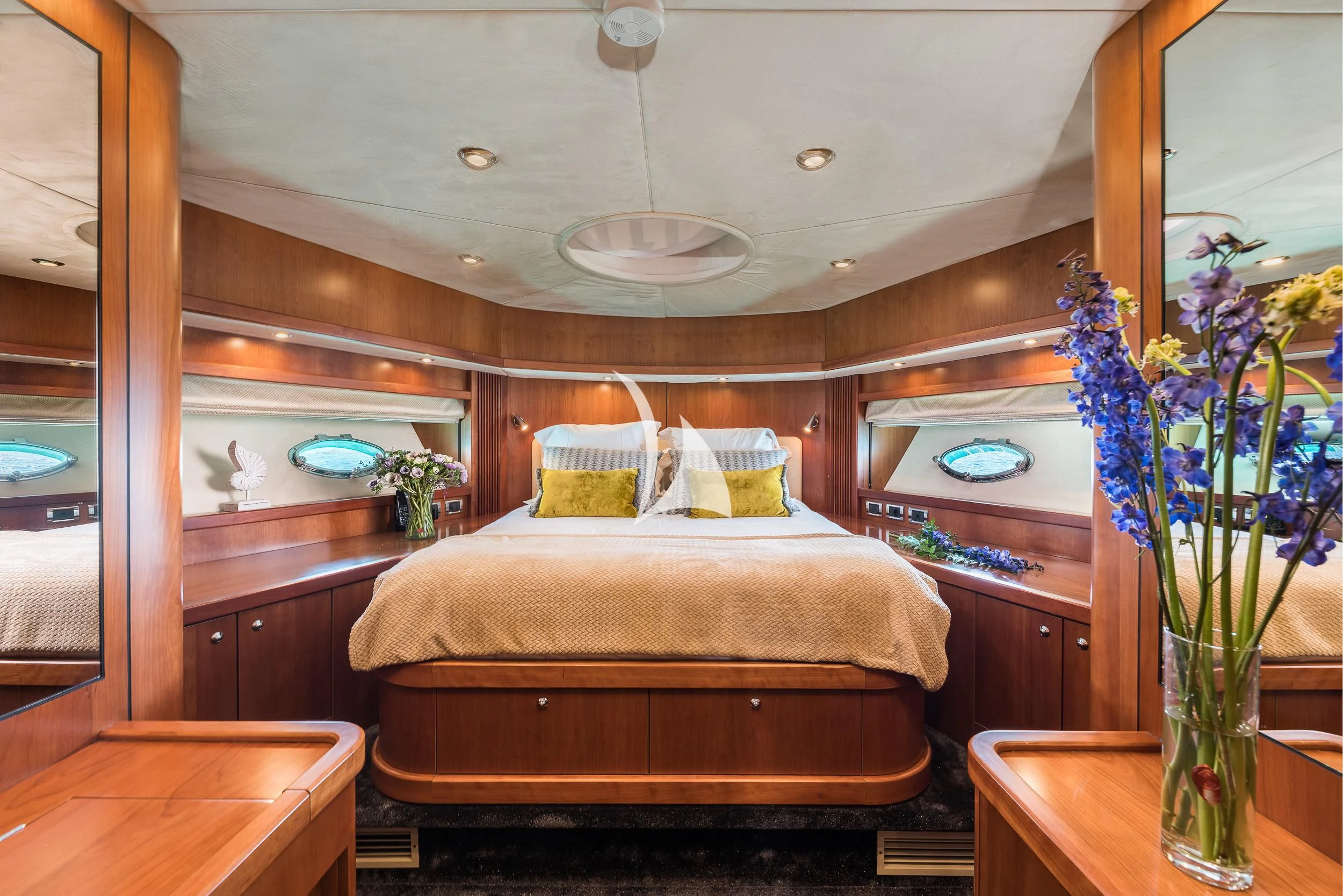 a room with a bed and a vase of flowers aboard FROGGY Yacht for Sale
