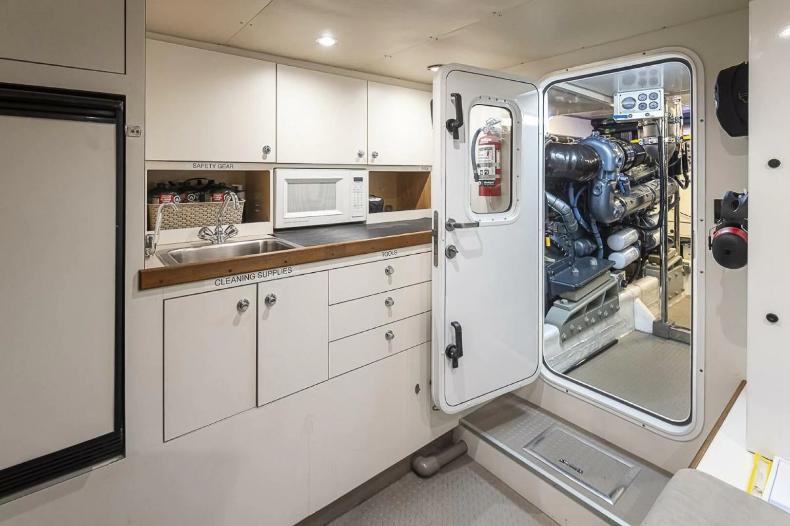 a kitchen with a sink and microwave aboard SEA SPUR Yacht for Sale