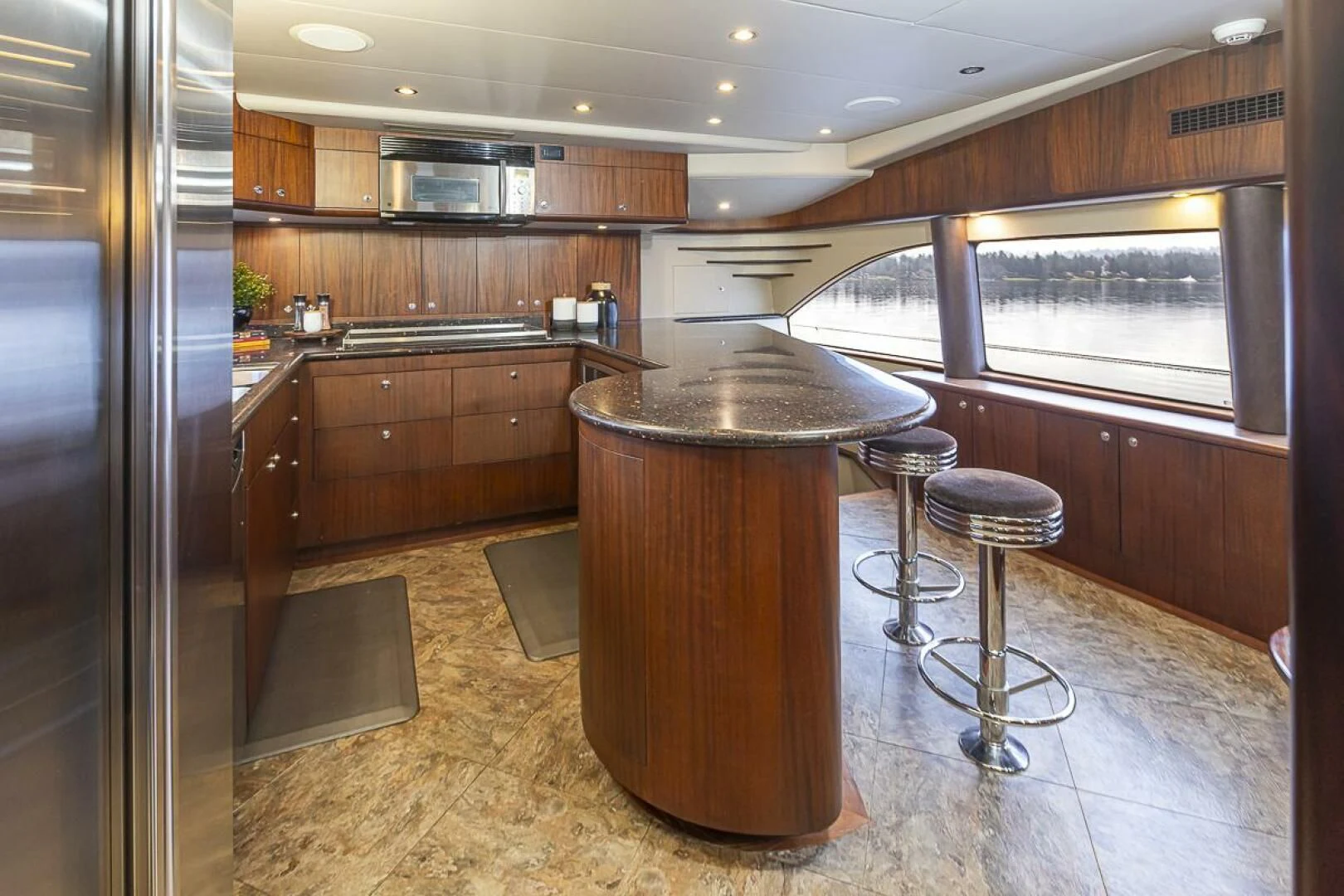 a kitchen with a bar and stools aboard SEA SPUR Yacht for Sale