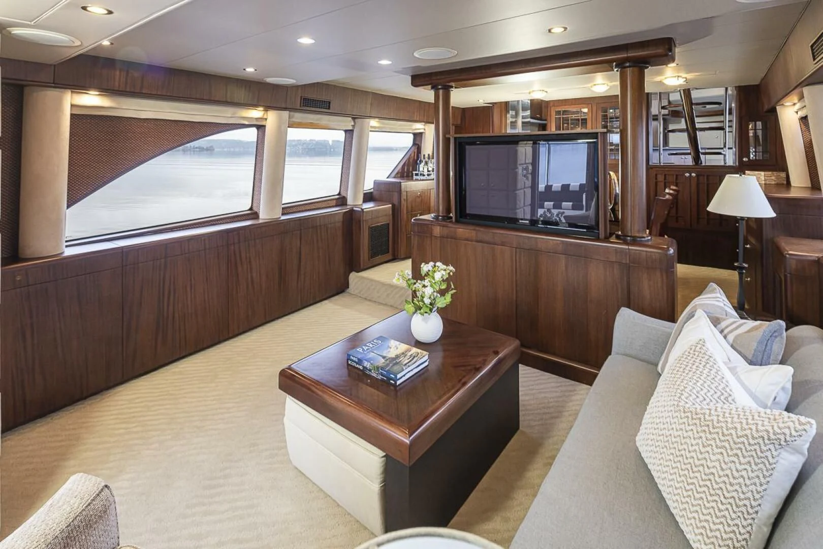 a living room with a tv and a table aboard SEA SPUR Yacht for Sale
