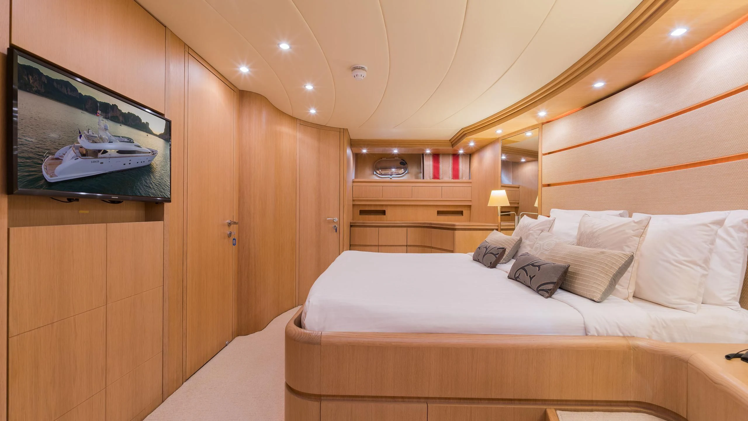 a room with a bed and a television on the wall aboard AVELINE Yacht for Sale