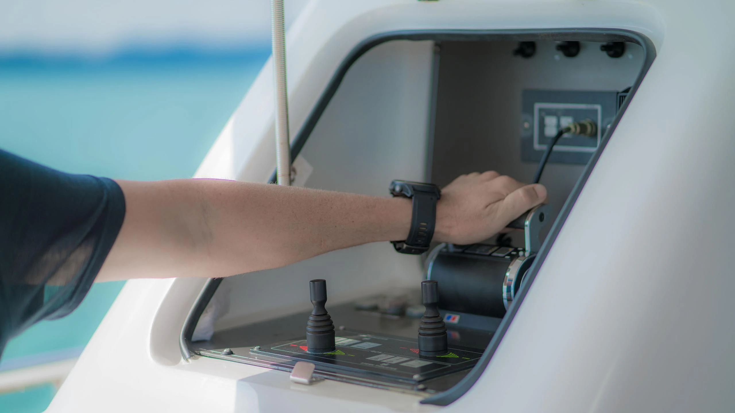 close-up of a hand holding a computer aboard AVELINE Yacht for Sale