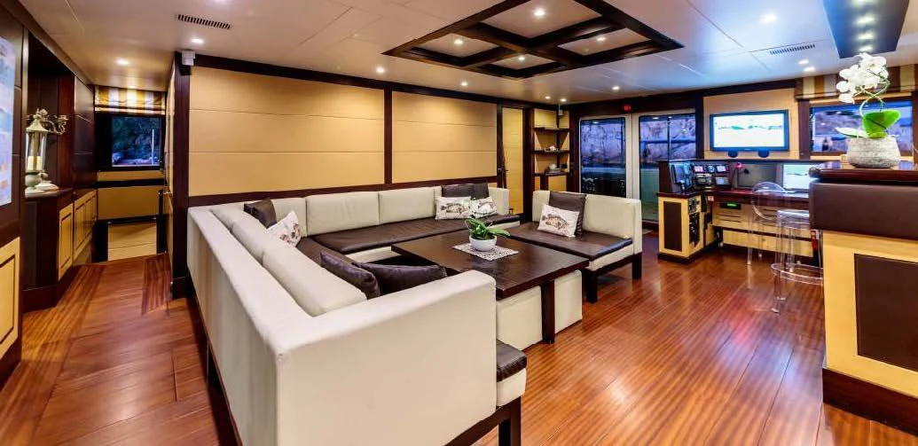 a living room with a large screen aboard ALLURES Yacht for Charter