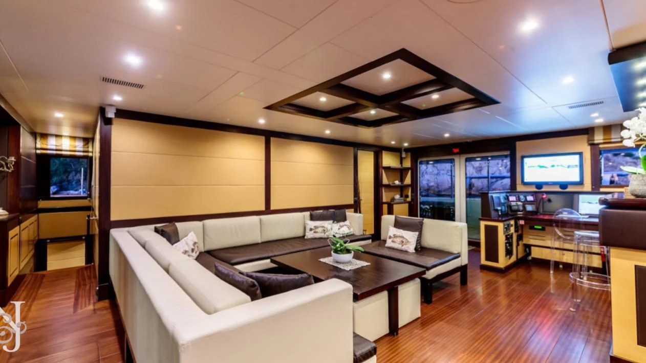 a living room with a large screen aboard ALLURES Yacht for Charter