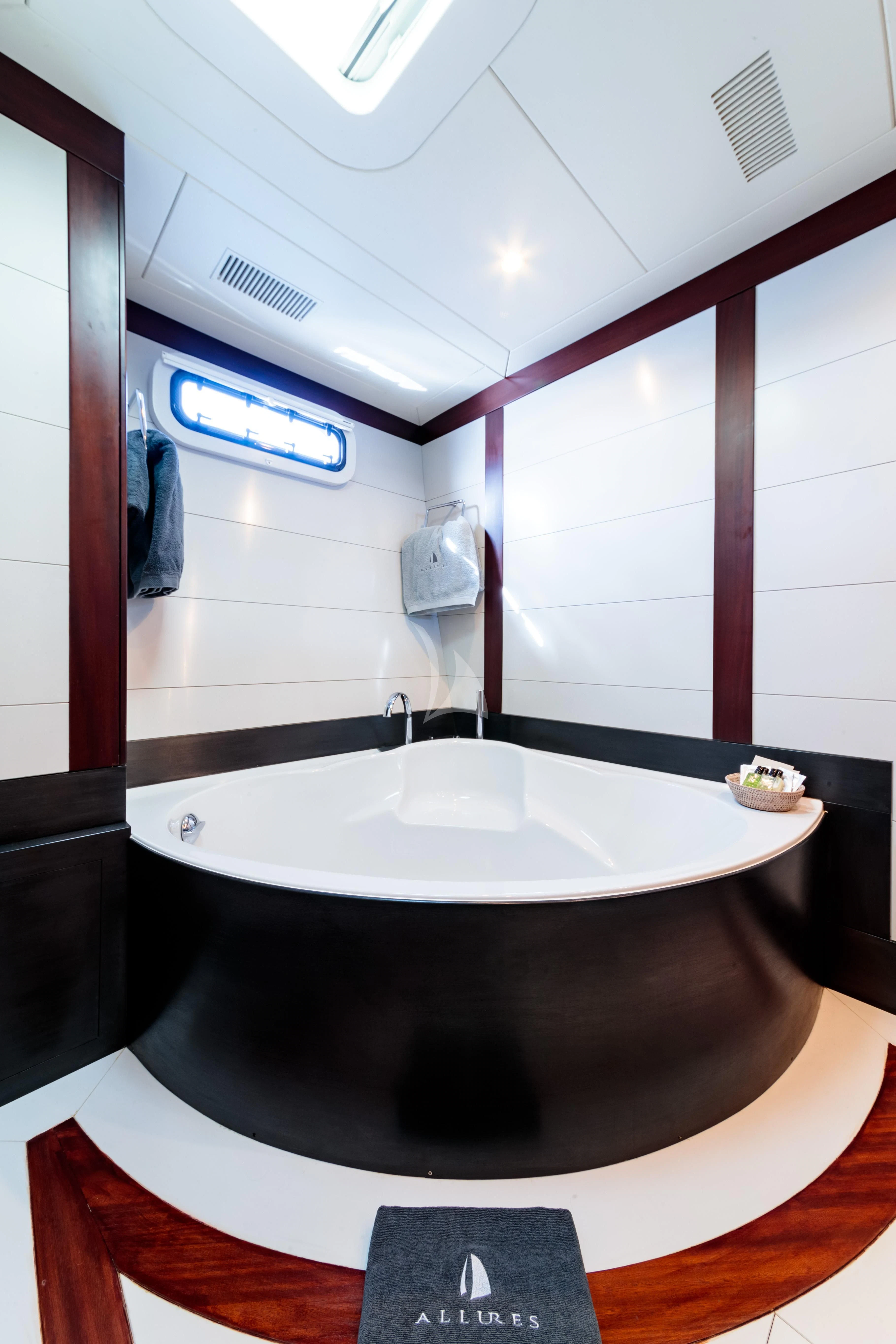 a bathtub in a bathroom aboard ALLURES Yacht for Charter
