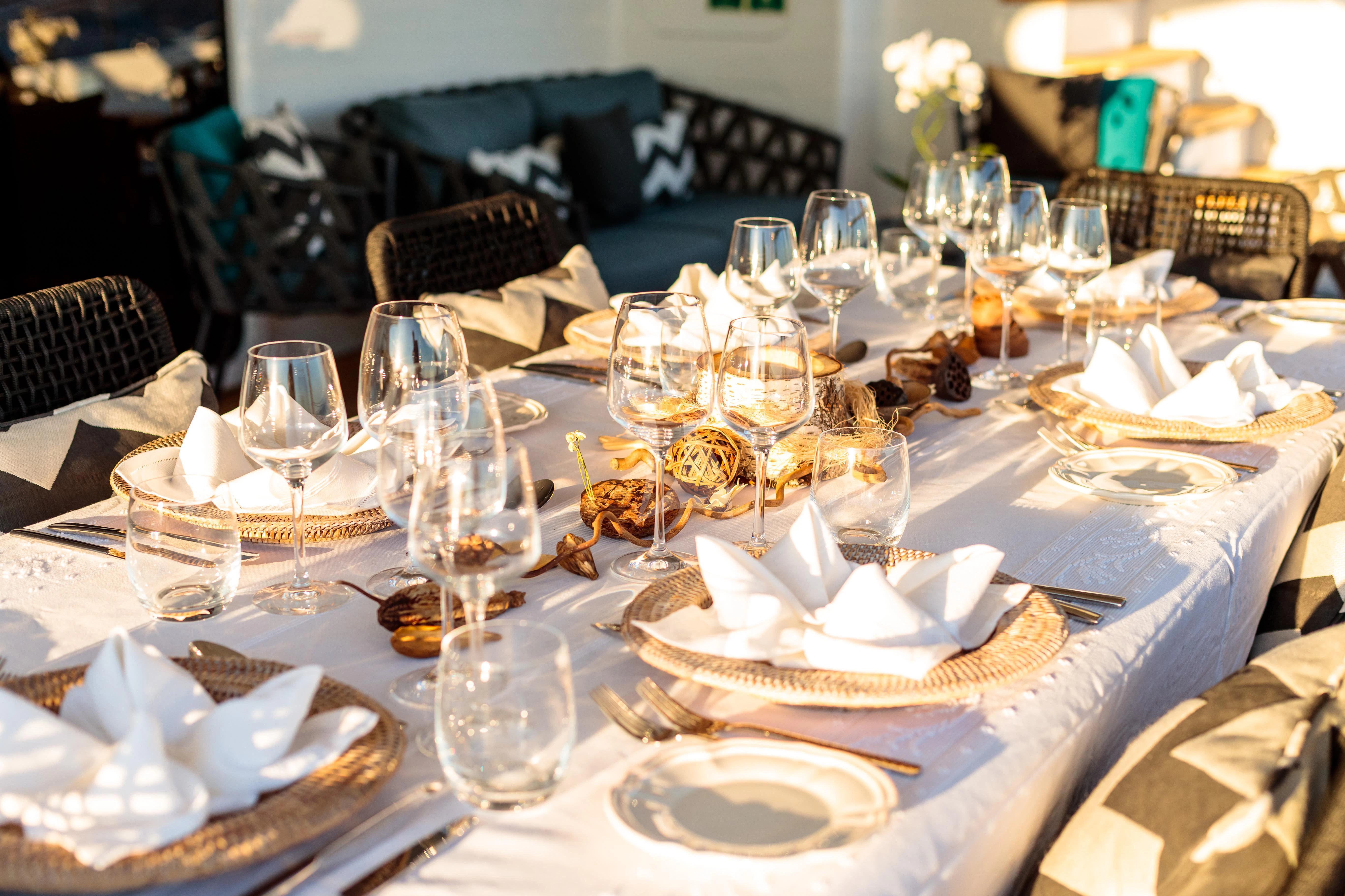 a table set with wine glasses aboard ALLURES Yacht for Charter