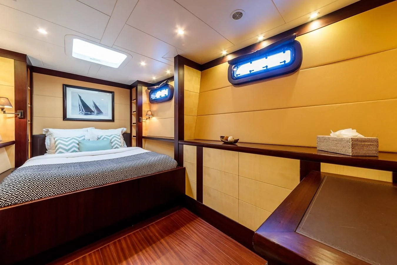 a bedroom with a bed and desk aboard ALLURES Yacht for Charter