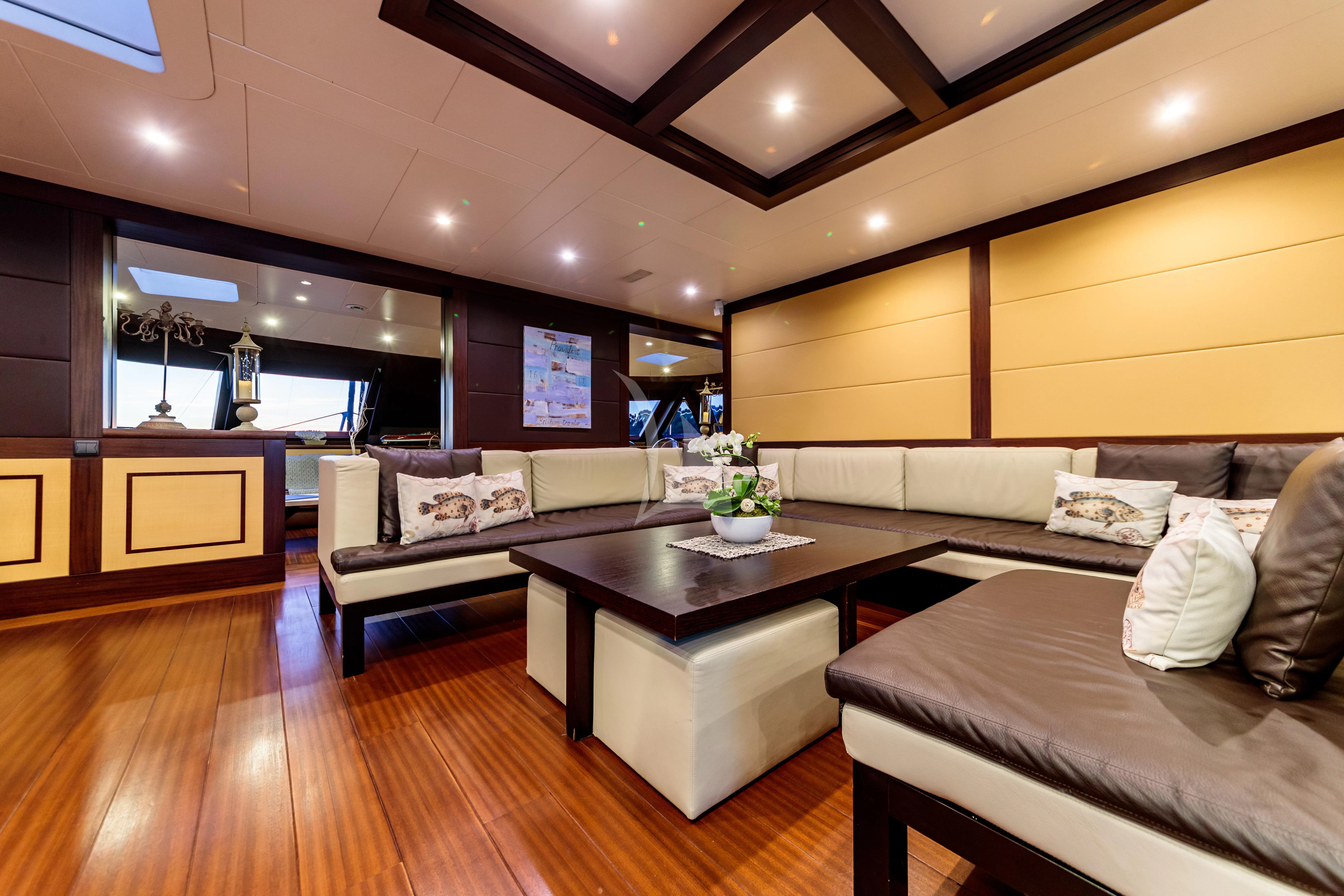 a room with a couch and a coffee table aboard ALLURES Yacht for Charter