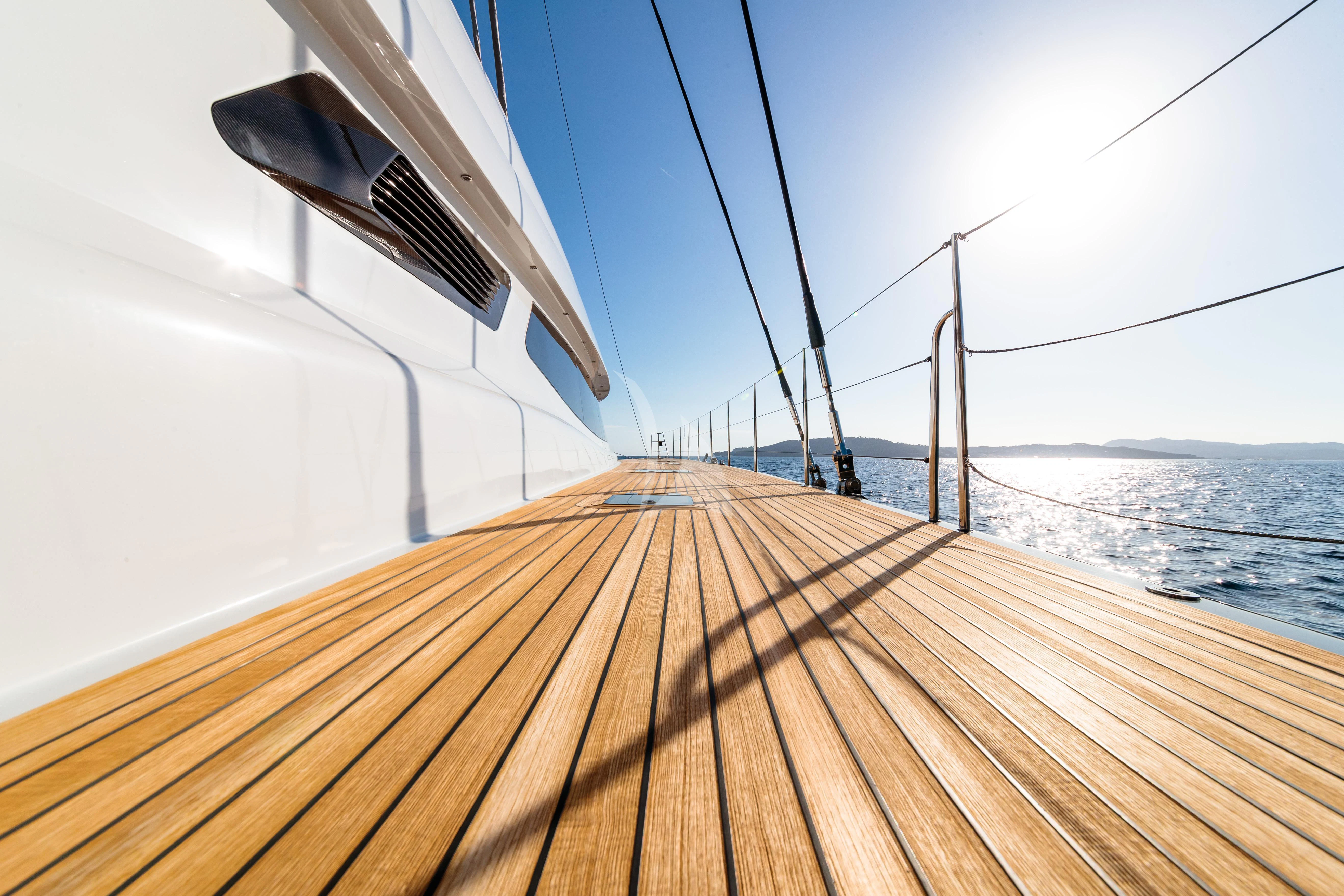 a wooden dock with a boat on it aboard ALLURES Yacht for Charter
