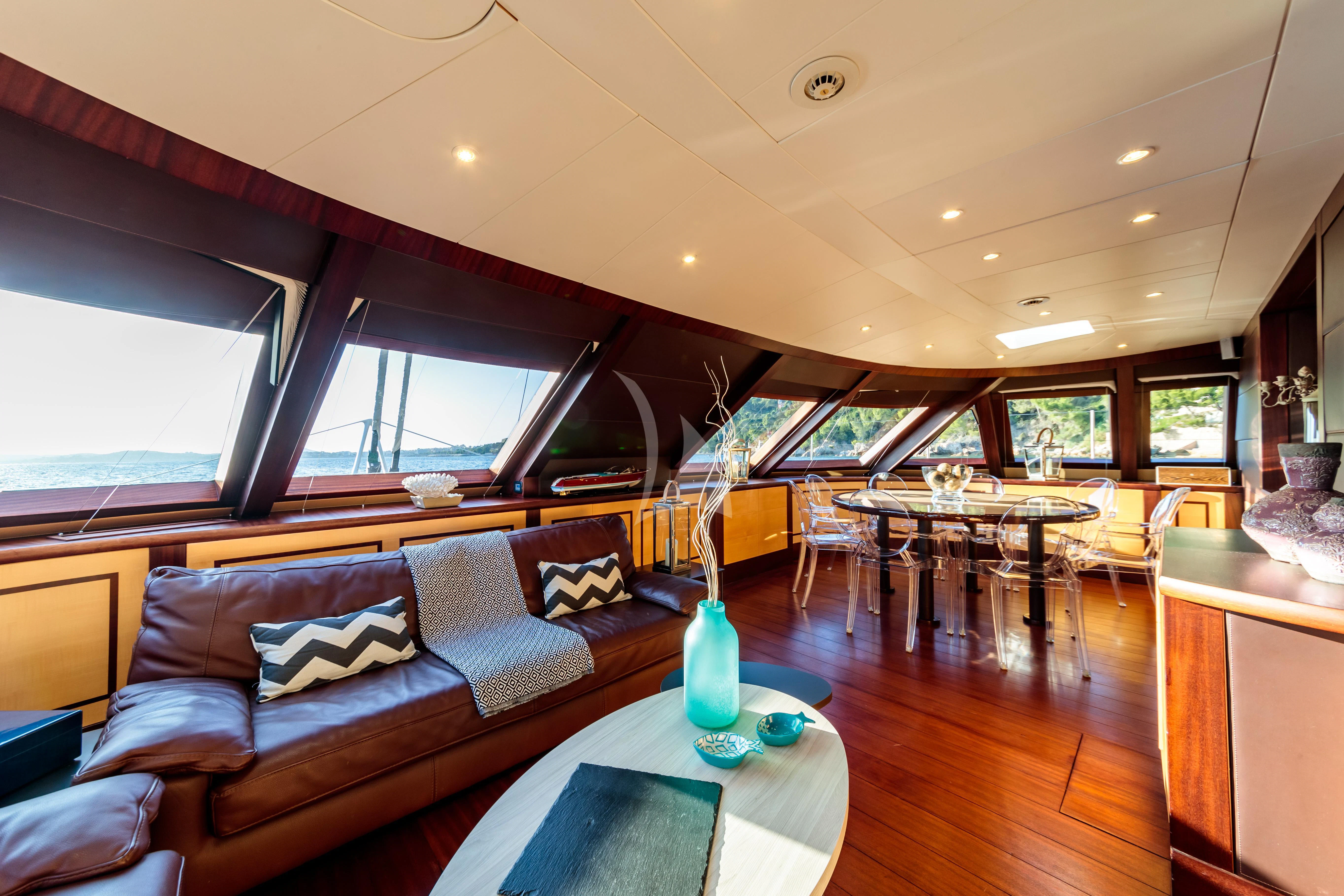 a living room with a couch and a table aboard ALLURES Yacht for Charter