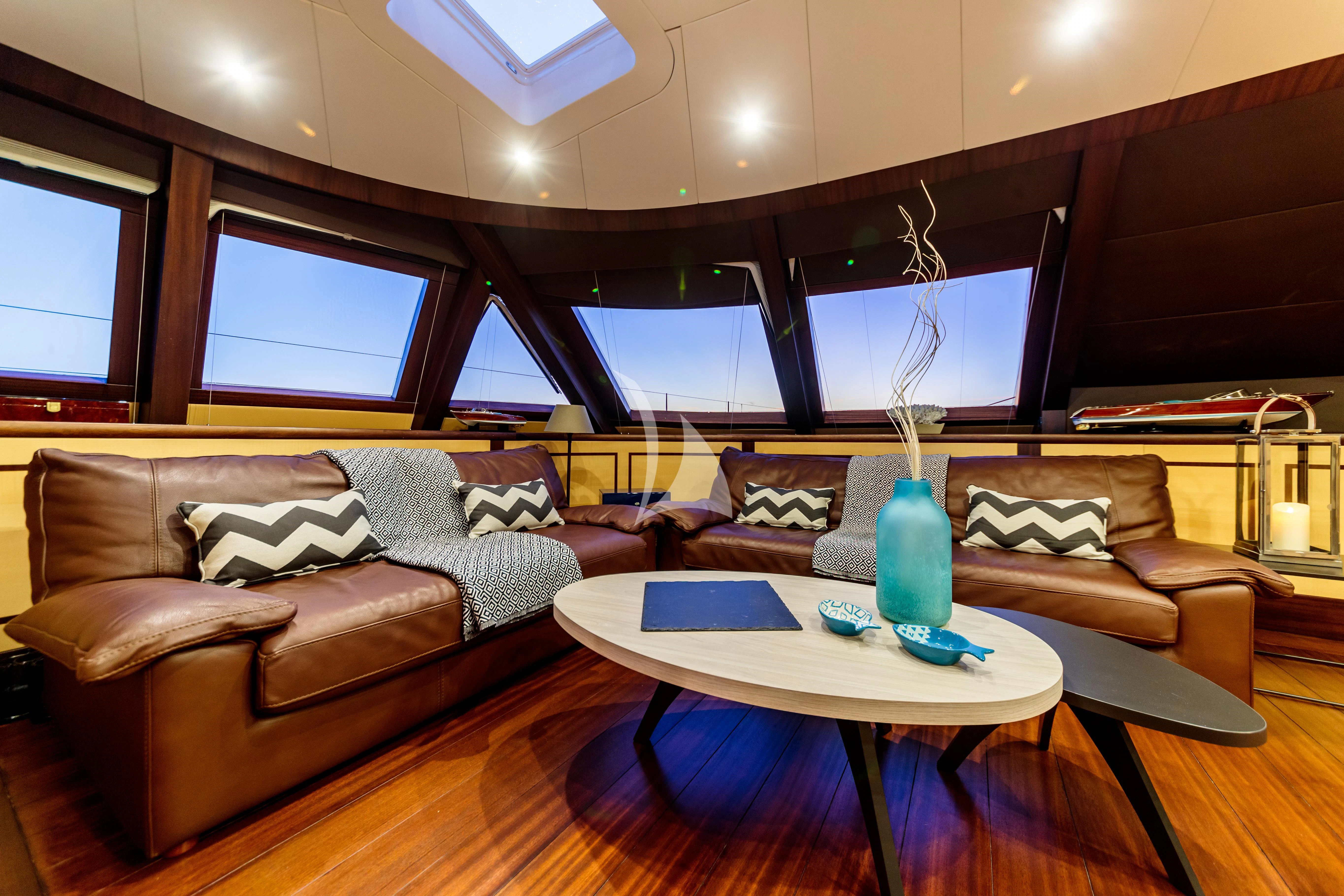 a living room with a couch and a coffee table aboard ALLURES Yacht for Charter