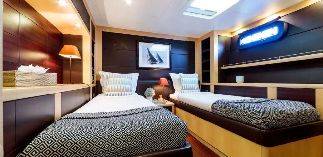 a room with two beds aboard ALLURES Yacht for Charter