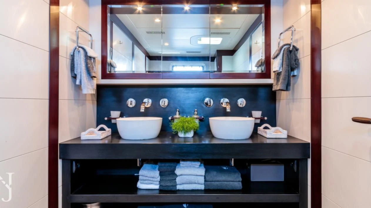 a bathroom with a large mirror aboard ALLURES Yacht for Charter